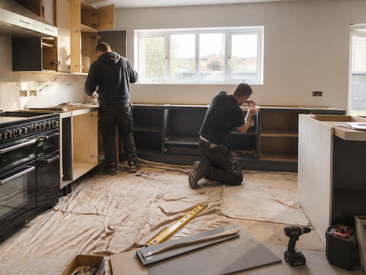 UK tradespeople fitting a new kitchen in a home